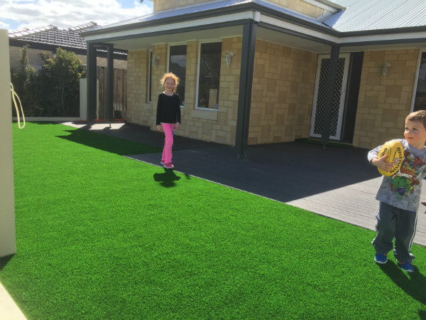  kids playing on synthetic turf on front yard in Perth 