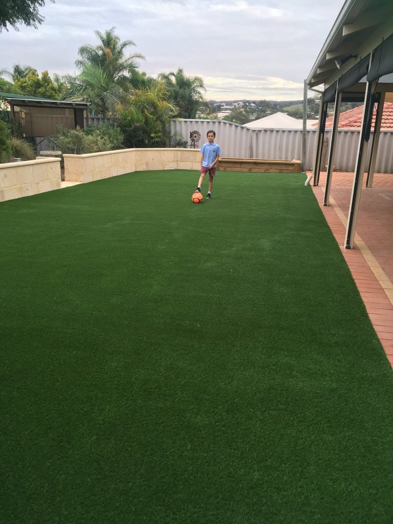 kids Playing on fake lawn Joondalup home Back yard